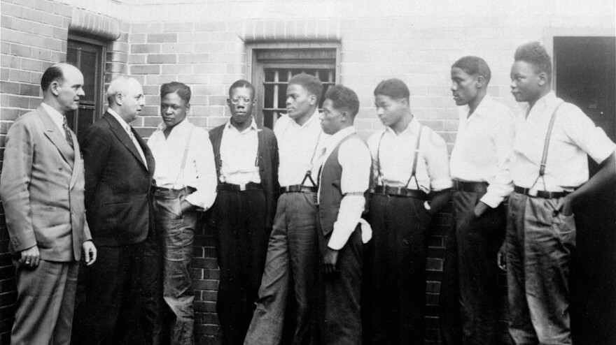 Attorney Samuel Leibowitz, confers with seven of the defendants in the Scottsboro rape case in 1935 in Alabama. Thursday, a judge pardoned the remaining three men who hadn't already been pardoned.