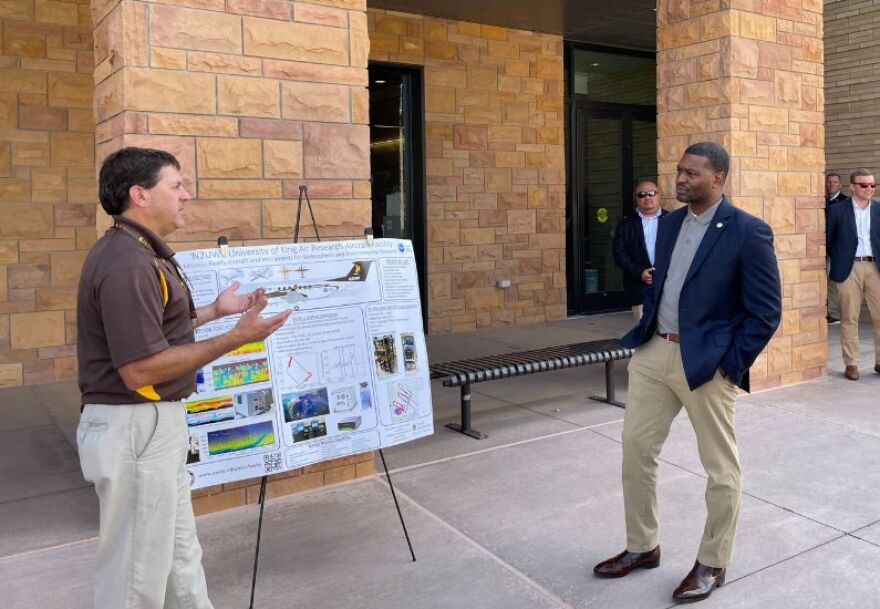 EPA Administrator Michael Regan (right) listens to a presentation at the University of Wyoming.