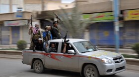 Syrian rebels celebrate in a street in the northeastern Syrian city of Raqqah after capturing the provincial capital on March 4. The government has responded with air strikes, creating a new wave of refugees.