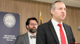 New Hampshire Attorney General John Formella announces the resolution of a case involving NSC-131, a hate group. Sean Locke, head of the state's Civil Rights Unit, is in the background.