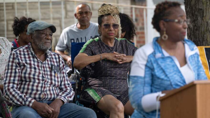 Cahokia Heights residents Yvette Lyle and Earlie Fuse listen as fellow resident Jeanette Green speaks on her own experiences with contaminated water during an Aug. 12 news conference, where Cahokia Heights residents and their lawyers discussed the Illinois EPA's recent citations against the community's water providers, the city and private water company Illinois American Water.