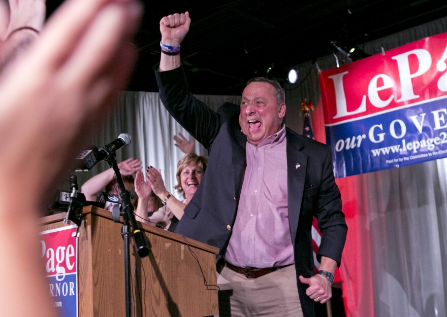 Gov. Paul LePage, with his wife Ann LePage, celebrates his re-election bid at his election night party, Tuesday, Nov. 4, 2014, in Lewiston, Maine. 