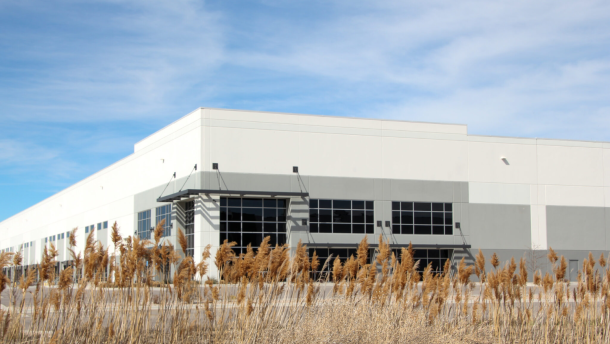 Outside view of a large white warehouse.