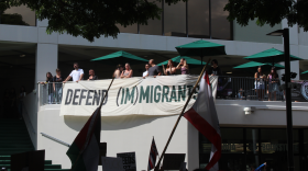 A banner reading "Defend (Im)migrants" is held during the "I.C.E Out Walkout" at UH Mānoa on Jan. 29, 2026