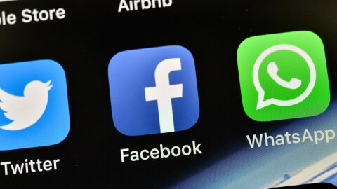 FILE - In this Thursday, Nov. 15, 2018 file photo the icons of Facebook and WhatsApp are pictured on an iPhone in Gelsenkirchen, Germany. (AP Photo/Martin Meissner,File)