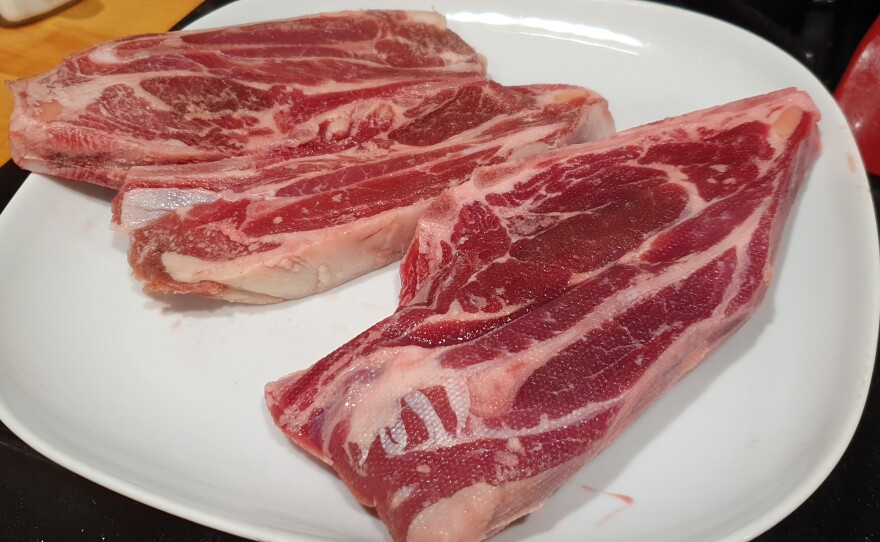 Lamb shoulder steak at the top; goat shoulder steak at the bottom