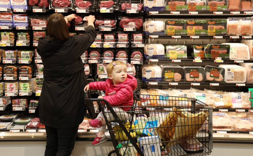 Eliabeth Antiochos and her daughter Lucy shop at the Whole Foods in Brighton on opening day, Wednesday, April 12, 2023.