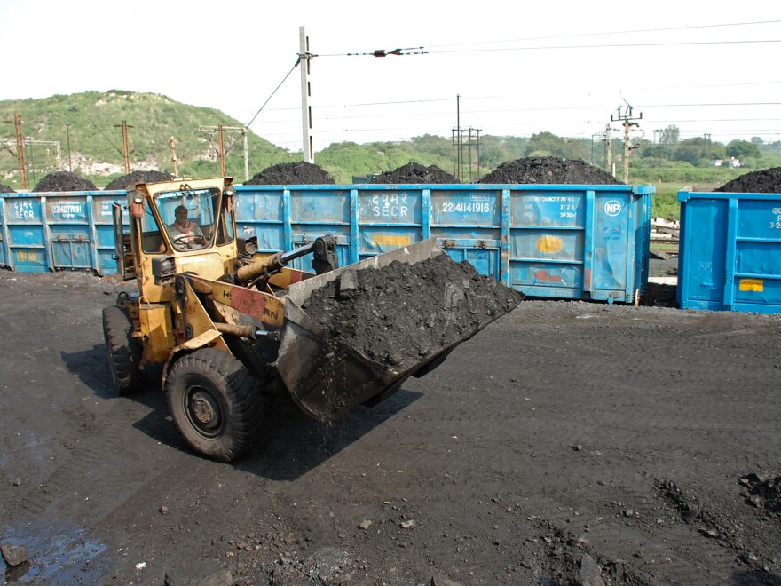 A bulldozer loads coal onto railway wagons at the Jharia coalfield in Dhanbad in India's Jharkhand state.