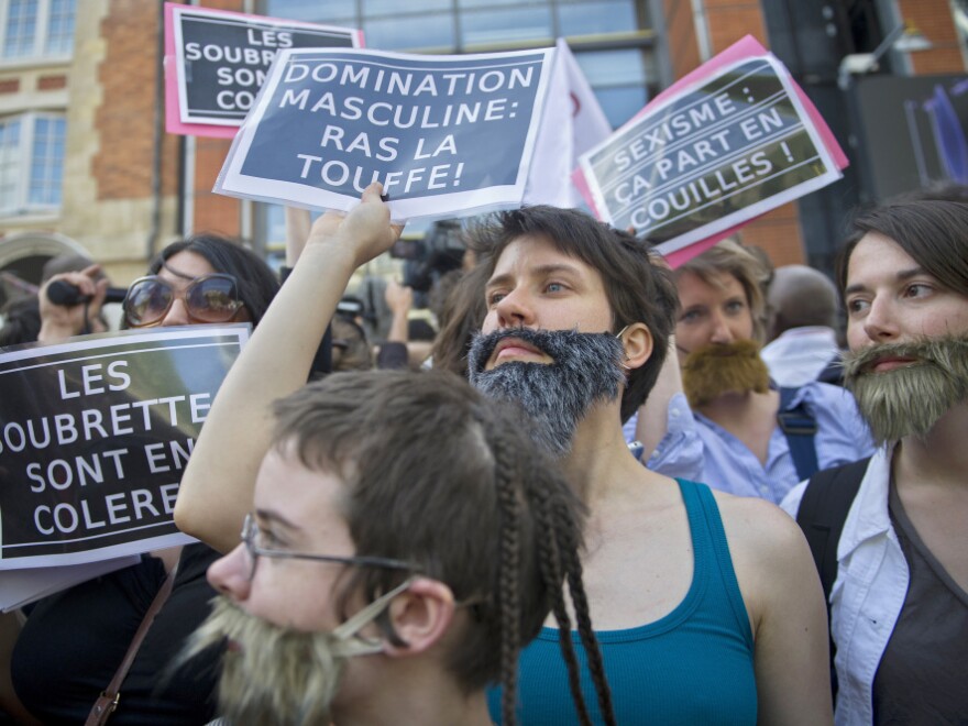 Women, mostly members of feminist groups, wear fake mustaches and beards, and hold anti-sexist placards as they stage a demonstration in Paris in May against the political and media reaction to the sexual assault allegations against former IMF chief Dominique Strauss-Kahn.