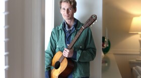 Tom Brosseau holding a guitar