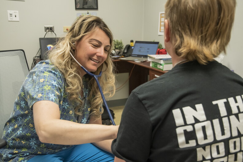 A nurse performs a checkup on a child.