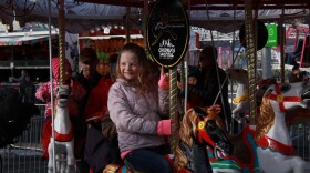 11-year-old Ashley Perry rides the Golden Carousel. Perry was the ceremonial ribbon-cutter. (Photo by Wesley Early, APRN - Anchorage)