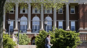 In this photo taken on Wednesday, May 13, 2015, a Sweet Briar College student walks past a building at the school in Sweet Briar, Va. The school nearly closed in 2015 amid financial difficulties. (Steve Helber/AP)