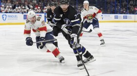 Tampa Bay Lightning defenseman Victor Hedman (77) cuts around Florida Panthers defenseman Nate Schmidt (88) and right wing Jesse Puljujarvi (20) during the second period of an NHL game Tuesday, April 15, 2025, in Tampa. The rivals will meet again in the first round of the playoffs.