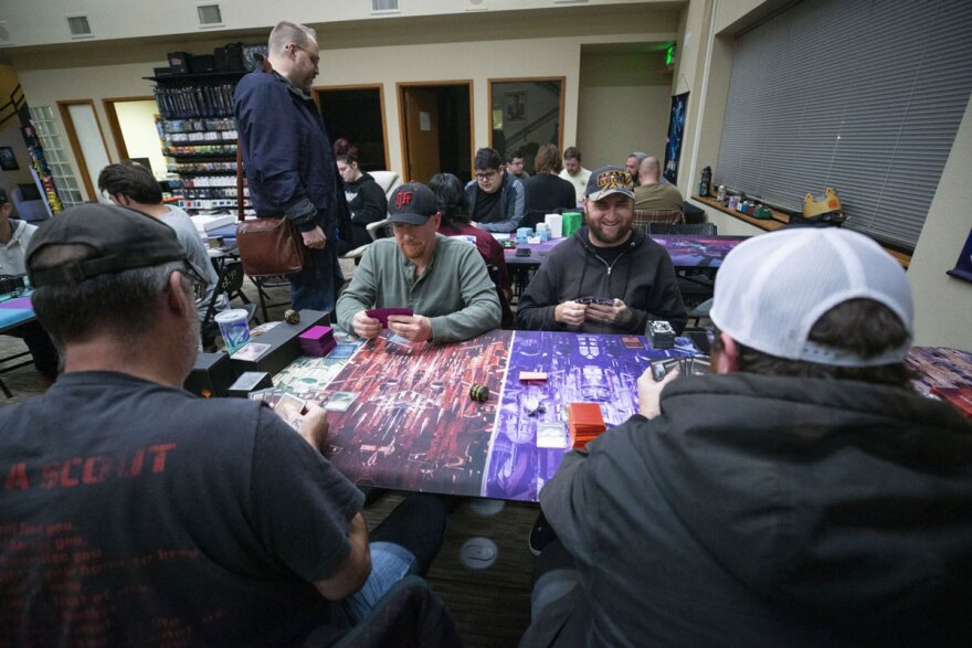 Army veteran Kevin Coleman, center right, laughs as he plays Magic: The Gathering with fellow veterans in a group called Veterans: The Gathering, Nov. 25, at Core Cards and Collectibles.