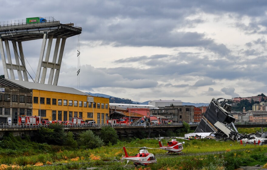 Rescue crews work at the scene of a bridge that collapsed Genoa, Italy, on Tuesday. Dozens of people are feared dead, after a large section of the Morandi Bridge, built in the 1960s, suddenly collapsed during a fierce rainstorm.