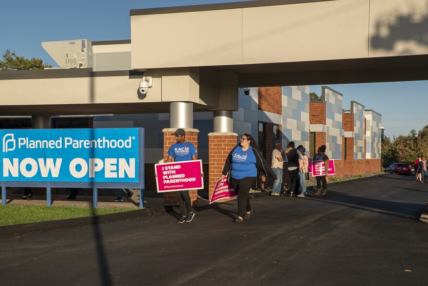 Pro-abortion activists gather in front of a Planned Parenthood clinic in Fairview Heights on Oct. 21. The clinic opened its doors to the region on Oct 23.