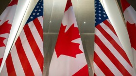 FILE - U.S. and Canadian flags are displayed before an event with Ontario Premier Doug Ford and the U.S. Chamber of Commerce, Tuesday, Feb. 11, 2025, in Washington. (AP Photo/Mark Schiefelbein, File)
