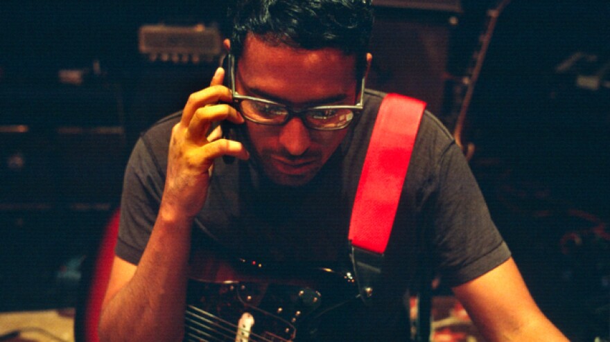 Drew Doucette takes a quick call between songs at Artisphere in 2011.