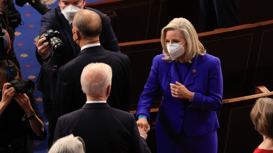 Cheney greets President Biden with a fist bump before his address to a joint session of Congress on April 28. Cheney responded to criticism by some GOP colleagues over the exchange by tweeting: "We're different political parties. We're not sworn enemies."