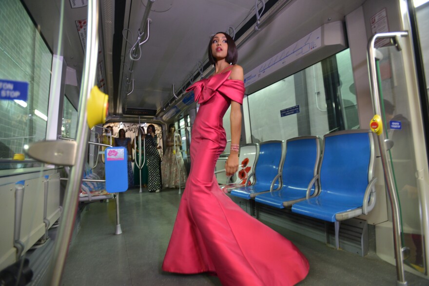 Olivia Roland practices her walk through the middle of a RideKC streetcar early in October to tape a promotional video for the Coalesce fashion show.