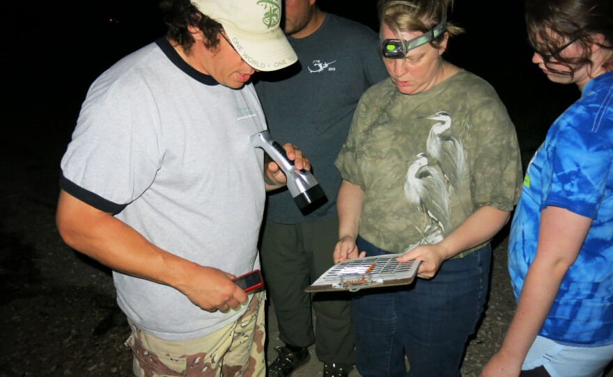 Jim Hewes, volunteer leader of the counting teams; Debbie Sullivan, volunteer counter; and her daughter Laurel Sullivan record their crab count on paper.