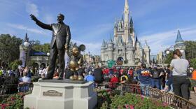 FILE - A statue of Walt Disney and Micky Mouse stand near the Cinderella Castle at the Magic Kingdom at Walt Disney World in Lake Buena Vista, Fla. on Jan. 9, 2019. With some workers across the U.S. threatening a walkout Tuesday, March 22, 2022, The Walt Disney Co. finds itself in a balancing act between the expectations of a diverse workforce and demands from an increasingly polarized, politicized marketplace. 