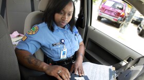 Miami Public Service Aide Tatayana Harris enters information into her laptop after clearing an accident in Miami's Little Havana community. Harris has been a Miami Police PSA for five years and hopes to become a police officer.