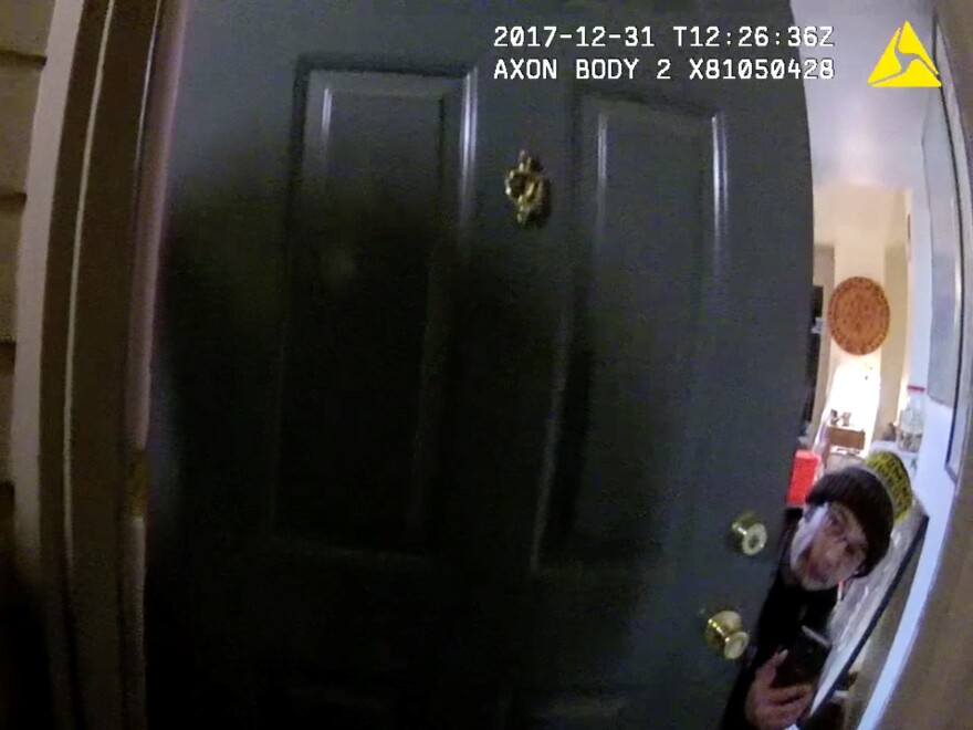Matthew Riehl peeks from behind the door of his apartment just minutes before he shot and killed a Douglas County sheriff's deputy and wounded four other law enforcement officers and two civilians in a shootout on New Year's Eve 2017.