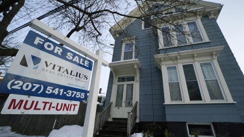 A sign announces a home for sale on Munjoy Hill, Wednesday, Jan. 25, 2023, in Portland, Maine.