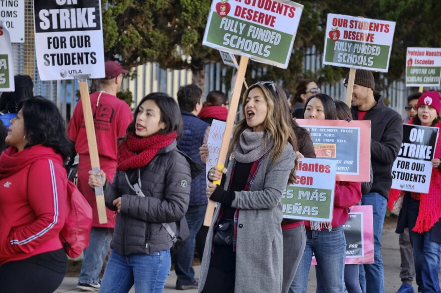 Striking Los Angeles Unified District teachers are joined by parents and students in front of Evelyn Thurman Gratts Elementary School in Los Angeles on Tuesday, Jan. 22, 2019. A tentative deal was reached Tuesday between Los Angeles school officials and the teachers union that will allow educators to return to classrooms after a six-day strike against the nation's second-largest district, officials said. (Richard Vogel/AP)