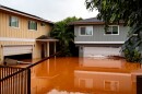 Floodwaters fill the ground level of homes in Waialua, Hawaiʻi, Friday, March 20, 2026.