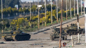 Syrian army tanks are seen stationed at the entrance to Baba Amr neighbourhood in Homs on Feb. 13, 2012. Syria ignored a new Arab initiative to end the bloodshed, with its troops pounding the protest hub of Homs as Russia said a ceasefire is needed before peacekeepers can be deployed. 