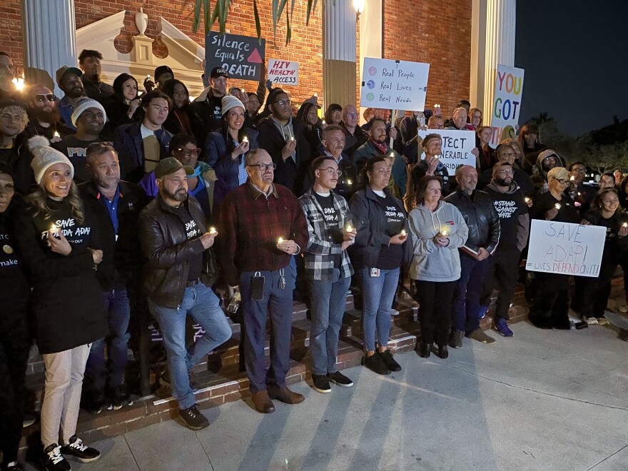 A group of people stand posed for a photograph on the steps of a church