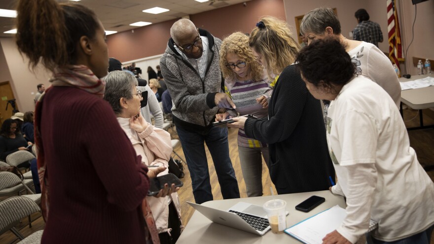 Nevada caucus volunteers receive training for recording results Thursday in Las Vegas.