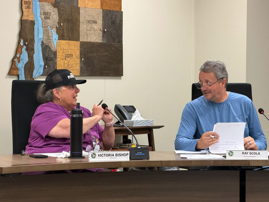 ntrim County Clerk Victoria Bishop, left, speaks with District 5 commissioner Ray Scola during a meeting in July 2026 in Bellaire. (Photo: Hayley Harding / Votebeat)