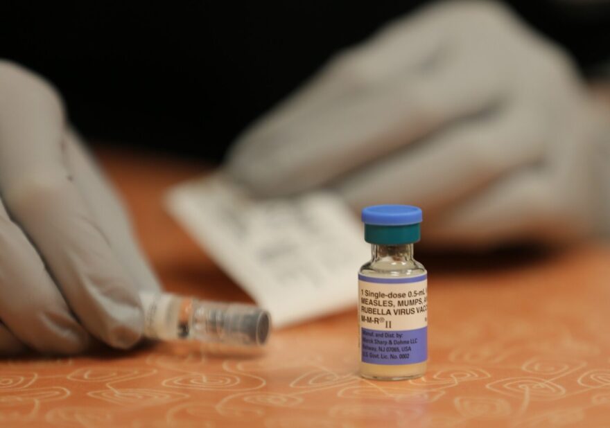 A nurse readies a measles, mumps and rubella vaccine.