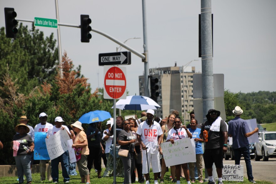 A crowd of people are stopped at an intersection.