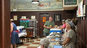Germania Maennerchor President Jim Kluesner (center, in green shirt) visits with the serving staff moments before the Volkfest opens for lunch on Thursday, Aug. 1