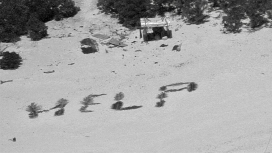 The crew of a Hawaii-based HC-130J Hercules aircraft makes contact with three mariners stranded on Pikelot Atoll, Yap State, Federated States of Micronesia, after dropping them a radio on April 8.