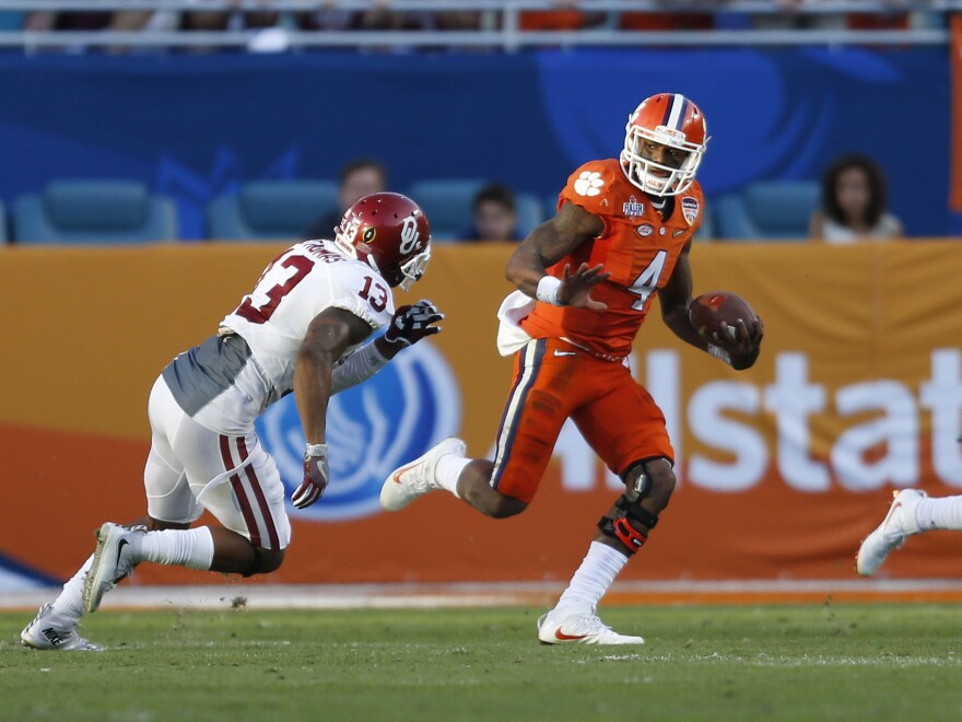 Clemson quarterback Deshaun Watson runs past Oklahoma's Ahmad Thomas during the college playoff semifinal game on New Year's Eve. Clemson won 37-17.