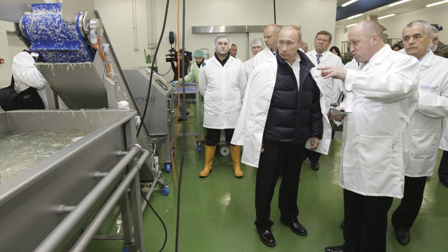 Yevgeny Prigozhin (second right) shows Russian President Vladimir Putin, center, around his Concord Catering factory, outside St. Petersburg in 2010. The company has secured large government contracts to provide school lunches and feed the Russian military.