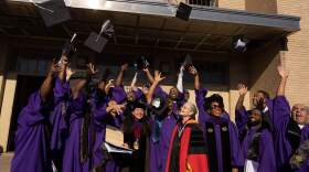 Northwestern Prison Education Program graduates throw their caps in the air. (Courtesy of Northwestern University)