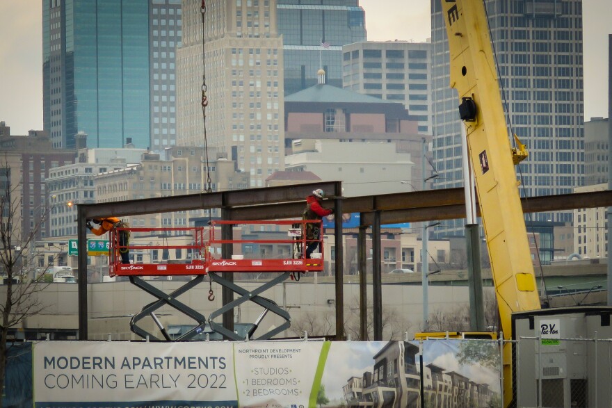 Workers attach a beam to the framework of apartments being constructed at Berkley Riverfront. The  construction is part of a Port KC program that requires projects include a minimum of 15 percent of units designated as affordable at 70 percent of area median income. 