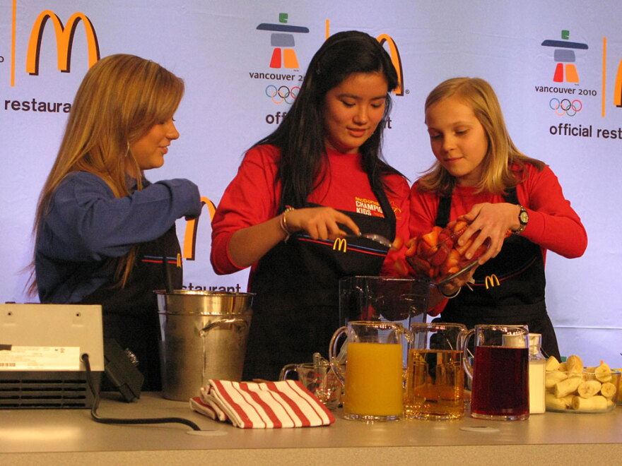 Gymnastics gold medalist Shawn Johnson (left) with her smoothie-making team of Jalena Keane-Lee, 14, from California, and Louisa Peters, 12, from Germany, at the event in which McDonald's rolled out a new line of smoothies.