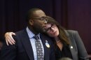 Florida Sen. Shevrin Jones, left, is hugged by Sen. Tina Scott Polsky after Jones spoke about his proposed amendment to a bill, dubbed by opponents as the "Don't Say Gay" bill, to forbid discussions of sexual orientation and gender identity in schools, during a legislative session at the Florida State Capitol, Monday, March 7, 2022, in Tallahassee, Fla. (AP Photo/Wilfredo Lee)