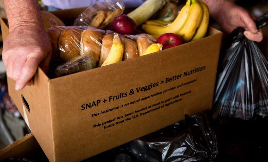 Volunteers from neighboring small towns divide, package and load their trucks with food from the Amarillo-based High Plains Food Bank for monthly delivery to Quitaque.