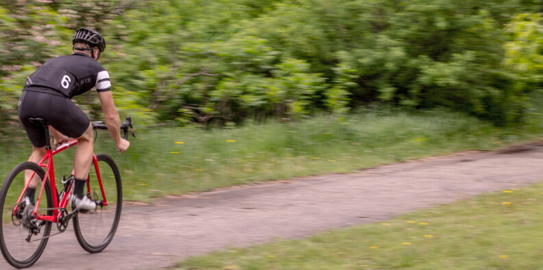 A man rides on a bike.