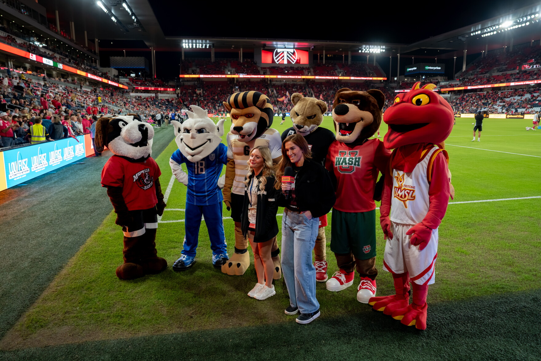St. Louis City SC in-game hosts pose with local college mascots, from left, Louie the Saint Bernard (Maryville University), the Billiken (Saint Louis University), Leo the Lion (Lindenwood University), Eddie the Cougar (Southern Illinois University Edwardsville), Forest the Bear (Washington University in St. Louis) and Louie the Triton (University of Missouri–St. Louis), on Wednesday, Oct. 28, 2026, at Energizer Park in St. Louis’ Downtown West neighborhood.