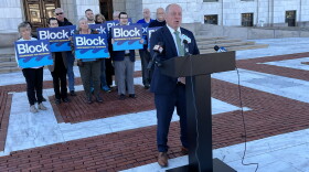 Independent gubernatorial candidate Ken Block speaks at a news conference outside the Rhode Island State House in Providence on Monday, Oct. 26, 2026, as supporters stand behind him. Block outlined 17 policy priorities and pledged not to undermine the Affordable Care Act if elected governor. Credit: Ian Donnis/Ocean State Media